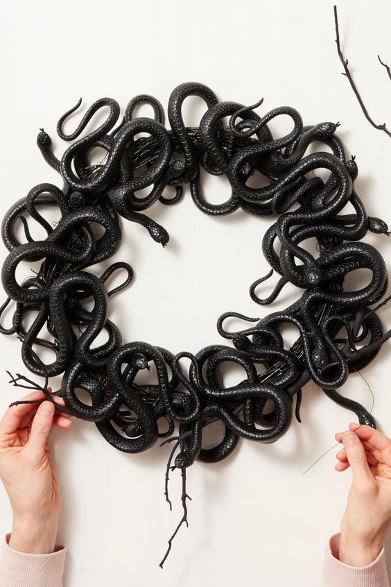 a catchy Halloween snake wreath can be easily made of a wreath form and some dollar store snakes