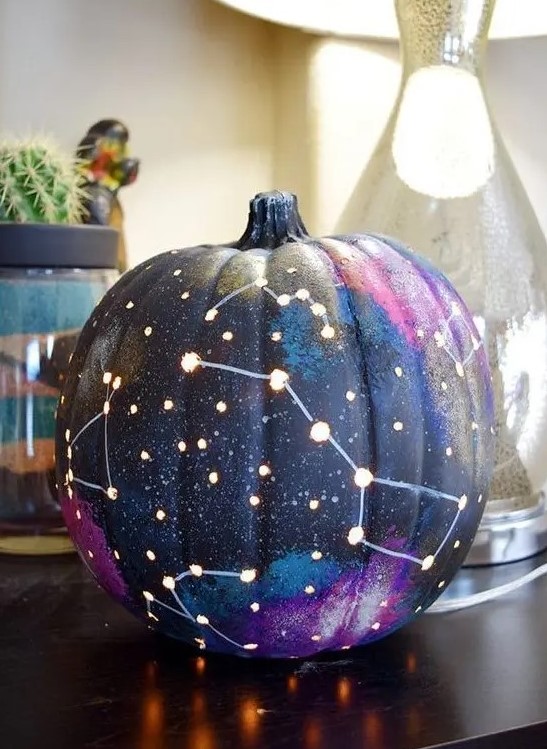 a galaxy pumpkin is a trendy idea for those of your who enjoy celestial Halloween decor and want something special