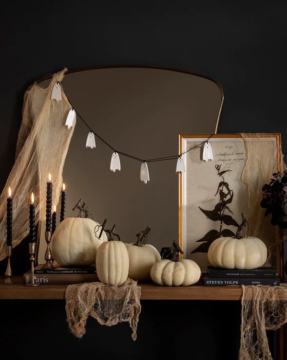 simple Halloween mirror decor with some cheesecloth and a ghost garland is a cool and fast to realize idea