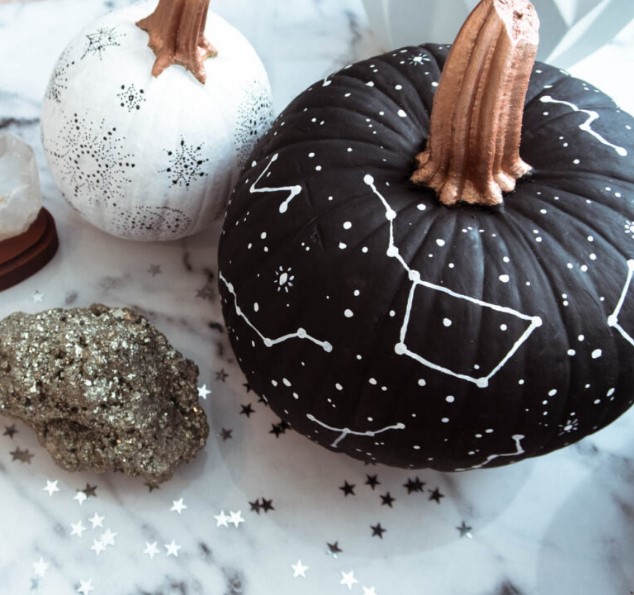 a matte black pumpkin with white constellations and stars drawn with a simple white sharpie is a gorgeous idea for Halloween