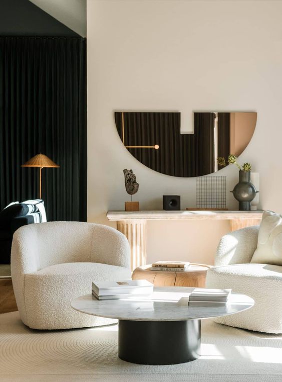 refined creamy curved chairs, a round coffee table and a side table, a console table with sophisticated decor