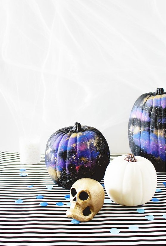 black, purple and gold galaxy-themed pumpkins are amazing for Halloween, bold, catchy and mysterious
