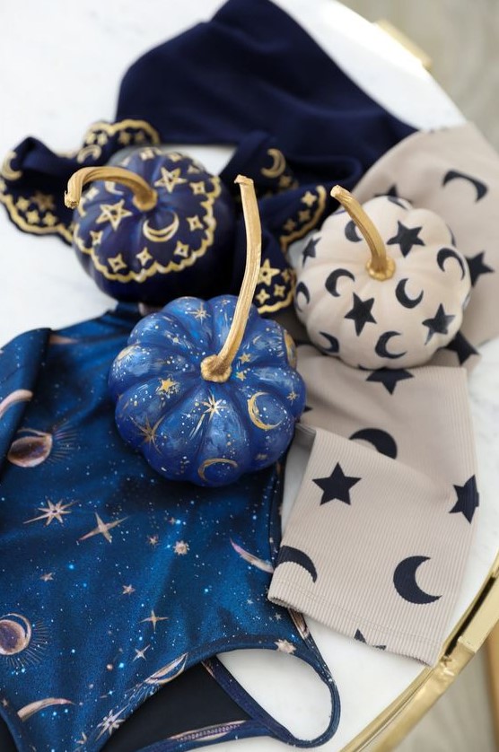 very pretty small pumpkins in blue, navy and white, with stars, moons and tiny sparkles are great for celestial Halloween parties