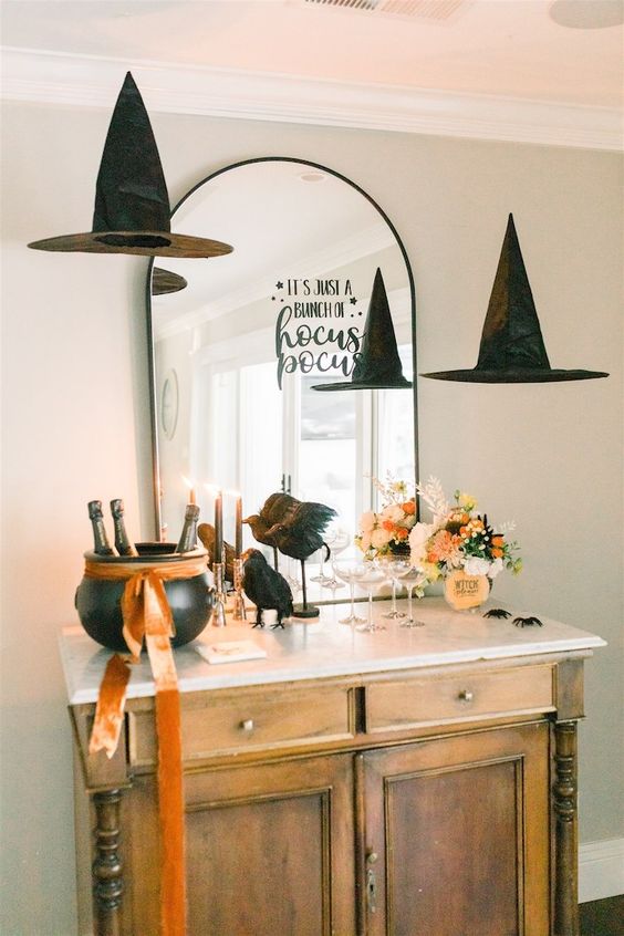 an arched mirror with a simple black letter sticker and witch hats floating around is amazing for Halloween