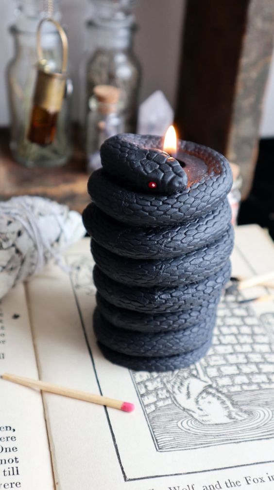 a black snake-shaped candle is a unique solution for Halloween decor, it looks wow