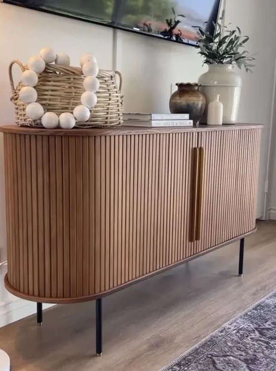a cool rounded sideboard with fluted appearance and handles, on tall legs is a lovely idea for a modern space