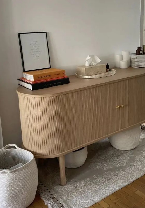 a beautiful curved fluted console table with tall legs is a super trendy piece as it shows off two trends - curved furniture and fluting
