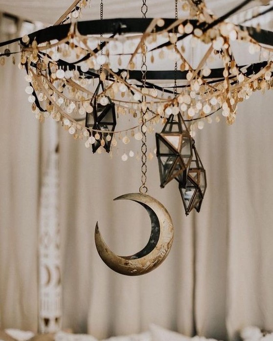 a chandelier with coins, 3D star candleholders and a moon will make your space very boho and celestial