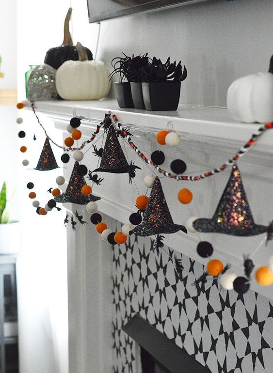 a cool Halloween garland of felt balls in white, orange and black and shiny witches' hats is a great idea to rock