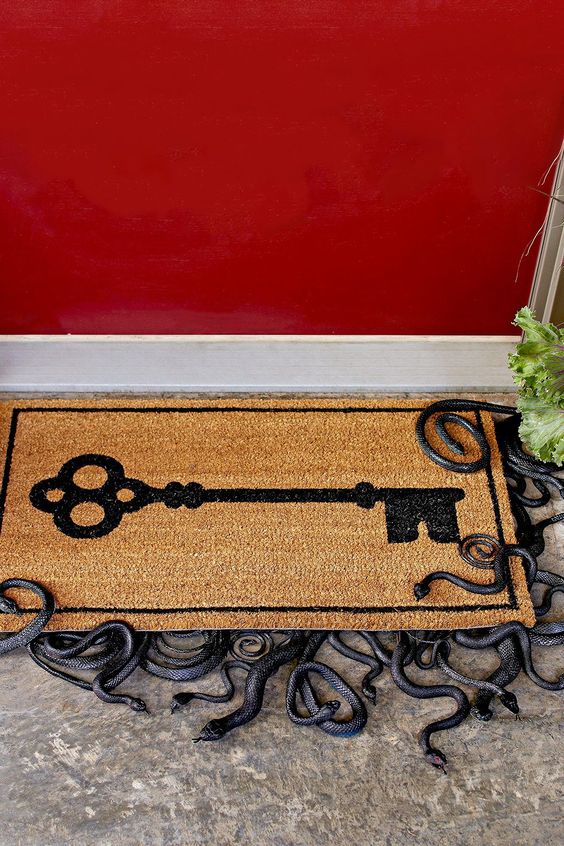 a door mat with small snakes underneath is a cool idea for Halloween porches
