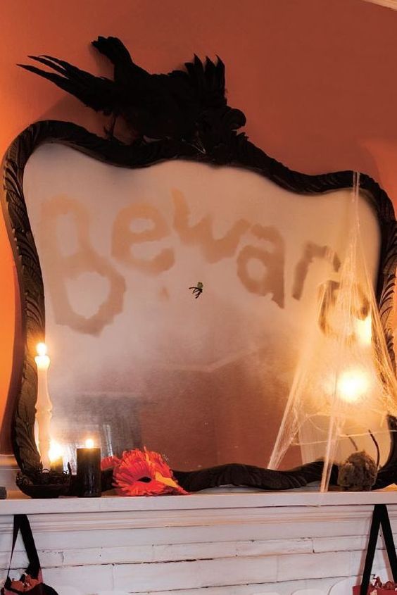 a black frame Halloween mirror with a words, some realistic blackbirds on top and some spiderweb is a cool idea