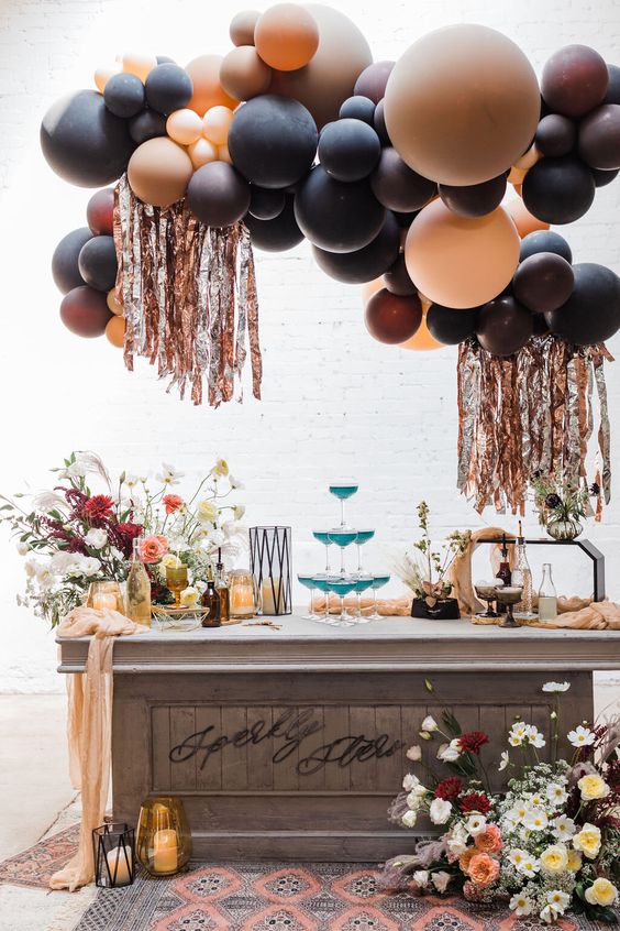 a jaw-dropping celestial Halloween bar with chic floral arrangements, a balloon installation with frigne and cocktails