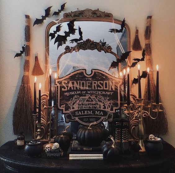 a couple of mirrors in vintage frames, with spiderweb, black bags and a black sign is a great idea for a Halloween entryway