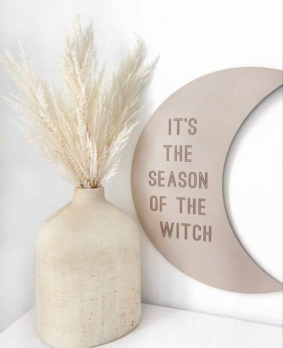 a moon sign with some words is a cool neutral Halloween party idea with a celestial touch