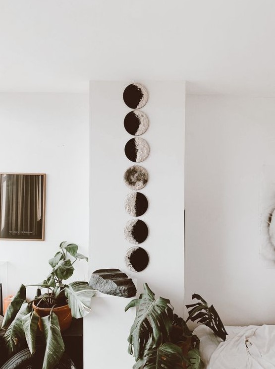 a wall art with moon phases is very lovely and looks modern and bold, perfect for a boho space