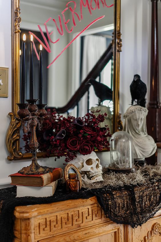 a mirror in a chic vintage gold frame with some bloody letters is a refined and bold solution for Halloween
