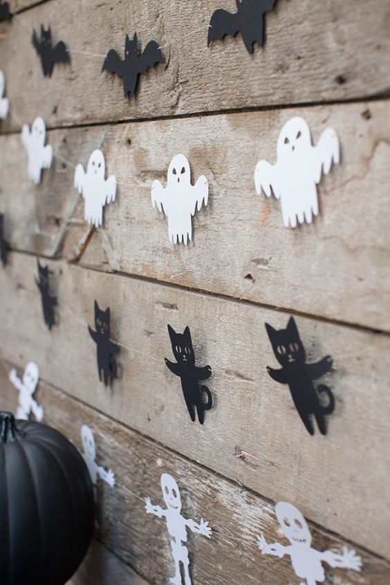 simple Halloween paper garlands of skeletons, ghosts, black cats and bats are great to style your space for Halloween