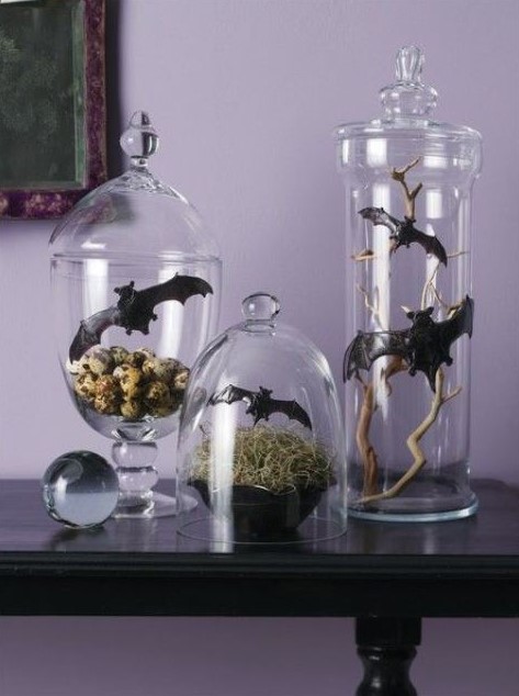 Halloween decor in jars and cloches, with hay, bats, branches and faux eggs is very chic and creative