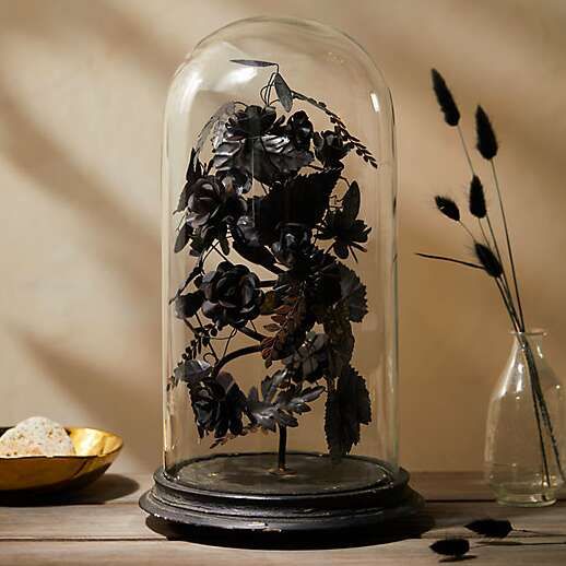 a Halloween decoration of a cloche with refined black blooms and leaves is a very sophisticated idea
