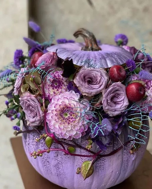 a beautiful lilac pumpkin styled with lilac, violet bloom, foliage and cherries is a lovely idea for Halloween decor