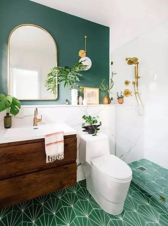 a chic modern bathroom with a green wall, white marble, a green printed tile floor, a floating wooden vanity