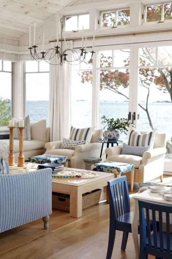 a coastal living room with gorgeous views, stripes, blues and much wood in decor