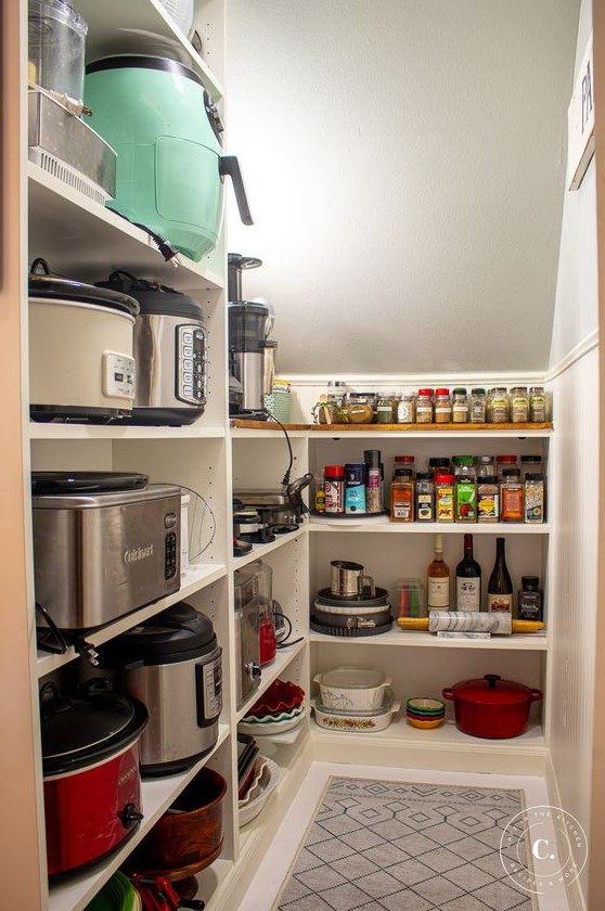 https://www.digsdigs.com/photos/2023/09/a-cool-staircase-pantry-with-a-built-in-storage-unit-with-open-shelves-that-allows-storing-a-lot-of-things-and-additional-lights.jpg