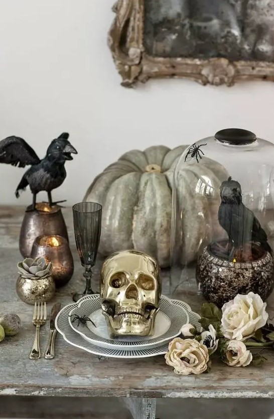 a heirloom pumpkin, a crow in a cloche, blackbirds, candles in chic candleholders for Halloween