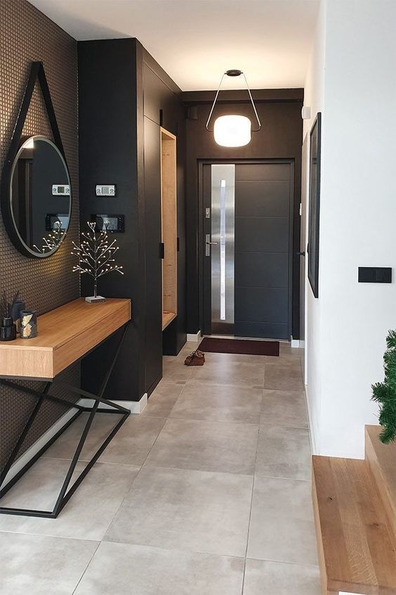 a modern soot entryway with a niche shelf and a bench, a stylish console table, a round mirror and a pendant lamp