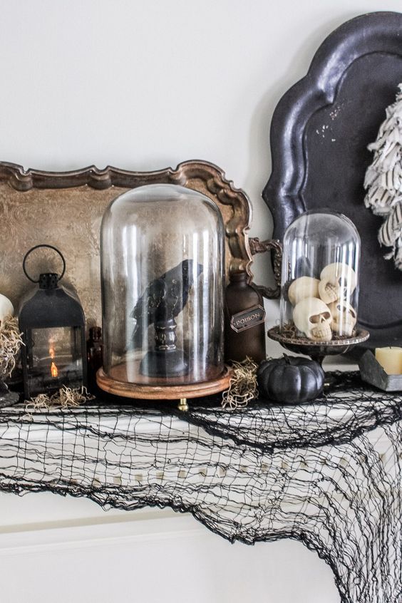 cloches with skulls and a blackbird are a great idea for a Halloween mantel, entryway or living room