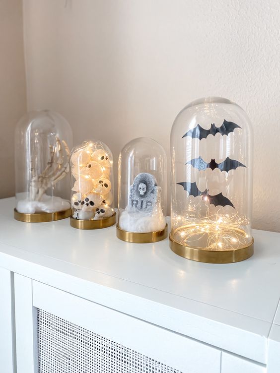 modern Halloween cloches with bats and lights, a tombstone, skulls and a skeleton hand are amazing