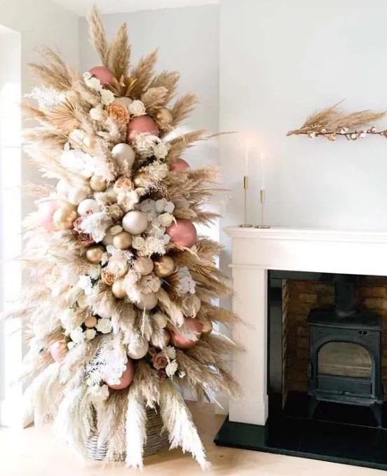 a creamy color pampas grass tree decorated with rose gold, gold and white ornaments plus blooms looks heavenly beautiful