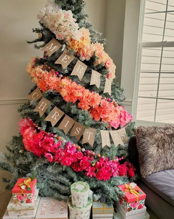 a fantastic ombre Christmas tree decorated with an ombre faux floral garland and colorful wooden beads is a lovely and bold idea