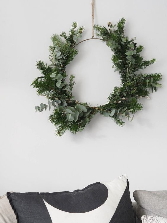 a modern Christmas wreath composed of a wire form, evergreens and eucalyptus is gorgeous and easy to make