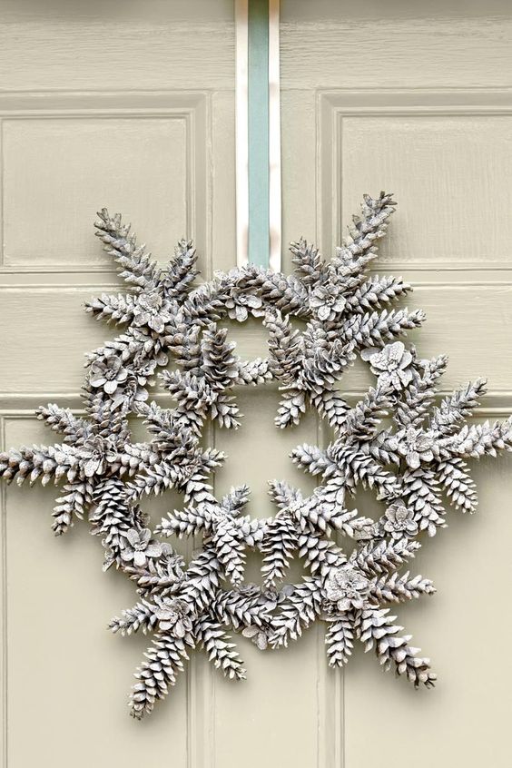 a modern Christmas wreath of snowy pinecones forming a snowflake is a cool and catchy idea to rock
