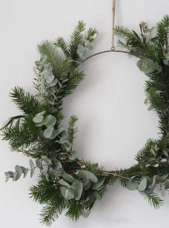 a simple and lovely Christmas wreath covered with evergreens and eucalyptus is a beautiful winter decor idea that will be actual after Christmas, too