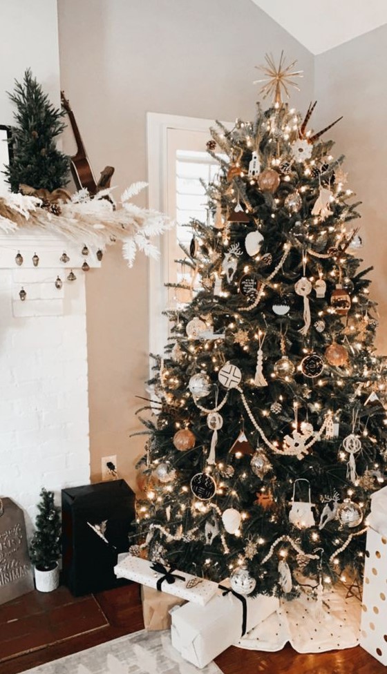 a stylish boho Christmas tree with lights, tassels, boho ornaments, chalkboard ones and some deer