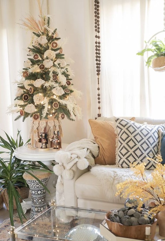 a tabletop boho Christmas tree with dried grasses, tassels, dried citrus slices and pampas grass on top