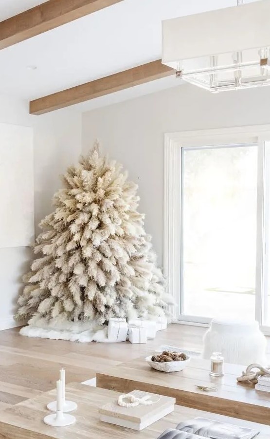 a white pampas grass Christmas tree with no decor and only lights is a fntastic solution for a boho feel in the space