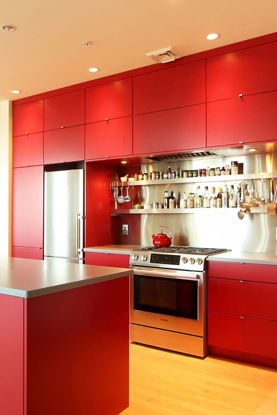 a bold red kitchen with matte cabinets, a stainless steel backsplash and shelves and built-in lights