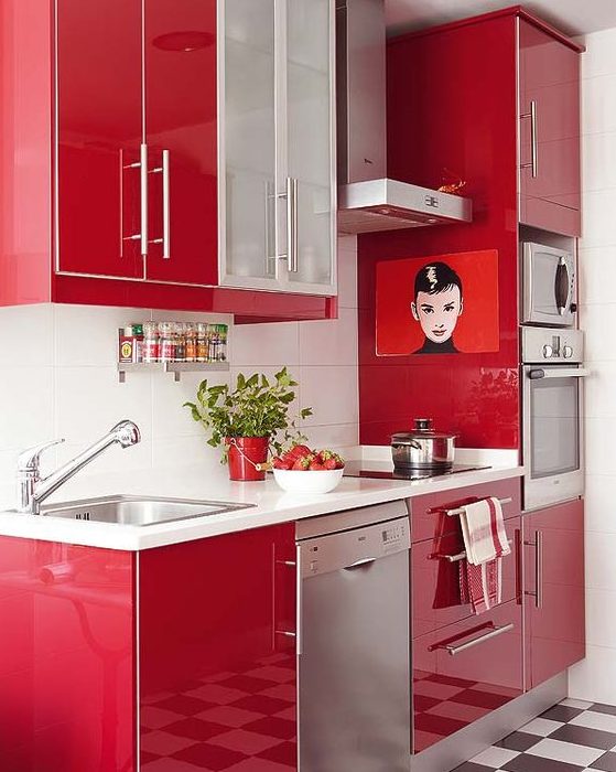 a bright red contemporary kitchen with a white backsplash and metal appliances looks laconic, bold and stylish