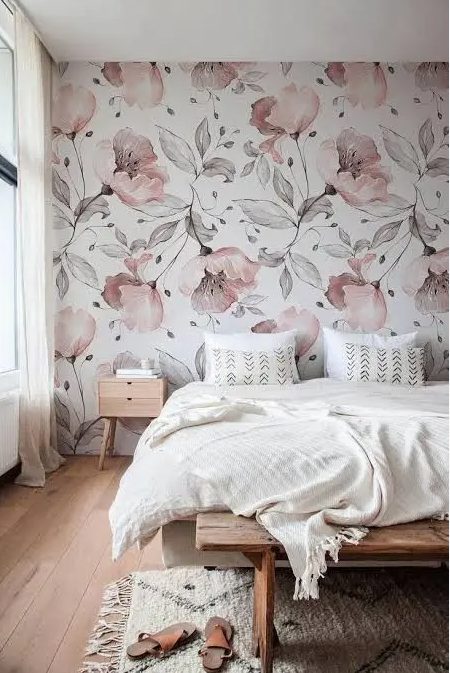 a-chic-bedroom-with-a-pink-floral-accent-wall-a-bed-with-neutral-bedding-a-stained-bench-and-a-nightstand-plus-a-neutral-rug.jpg