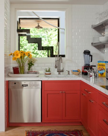 a hot red L-shaped kitchen with shaker cabinets, white subway tiles, open shelves and stainless steel appliances