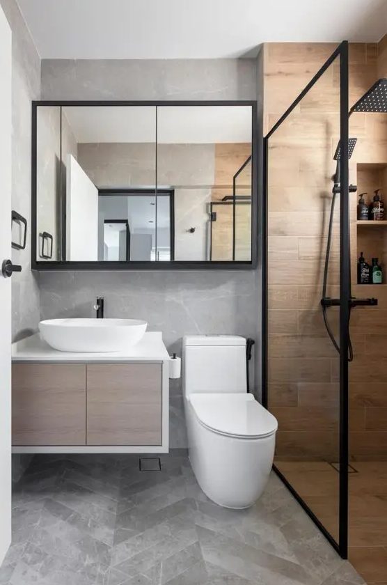 a small contemporary bathroom with a floating vanity, a shower space clad with wood tiles, a chevron floor, black touches for a contrast