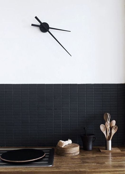 a chic matte black mini tile backsplash looks sleek and adds texture and interest to the space making it bold and pretty