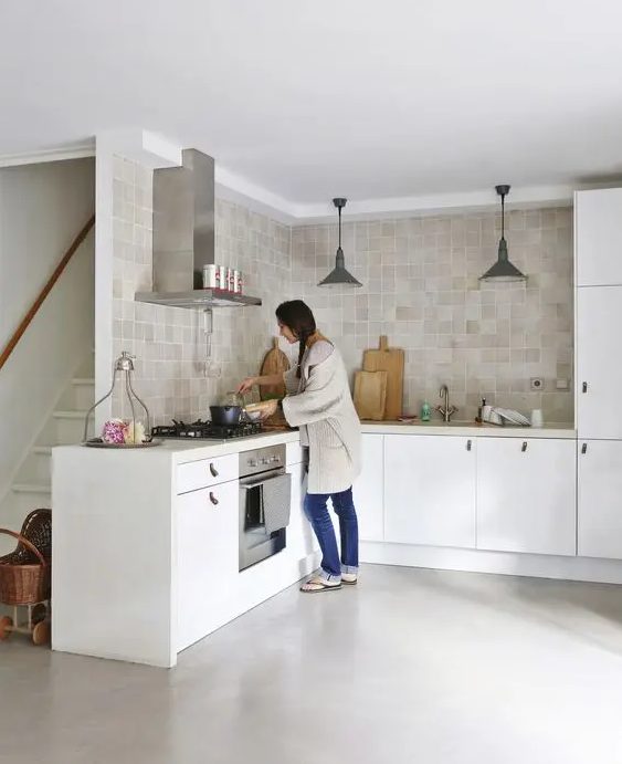 a customized white IKEA kitchen spruced up with neutral tan and beige zellige tiles covering two walls and adding color to the space