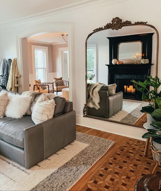 a-large-mirror-in-an-ornated-frame-hanging-opposite-the-sofa-is-a-cool-solution-to-make-the-space-larger.jpg