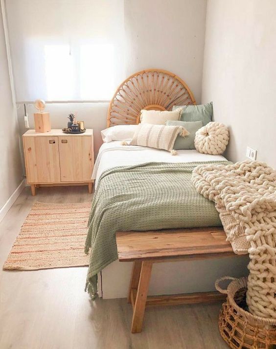 a little narrow guest bedroom with light-stained furniture, mint and neutral bedding, chunky knit pieces