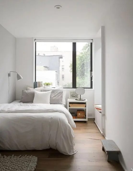 a minimal bedroom with a daybed, a bed with neutral bedding, a nightstand, a bench and a sconce is welcoming