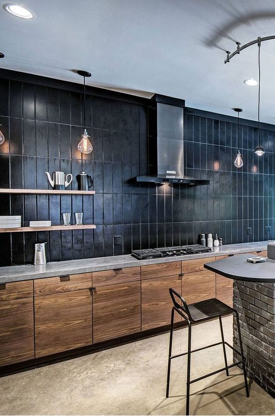 a minimalist stained kitchen with a grey quartz countertop plus a black large scake stacked tile backsplash that takes a whole wall